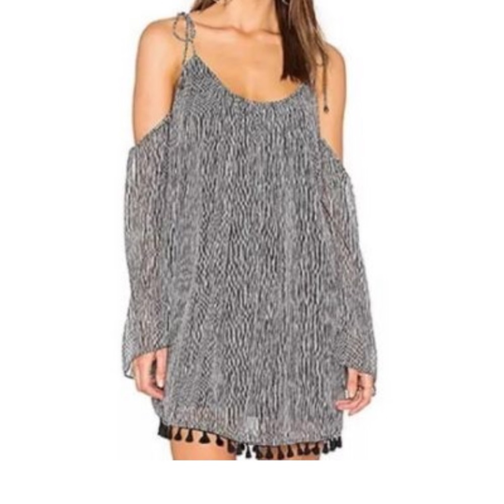 Off the shoulder dress with tassel hem.